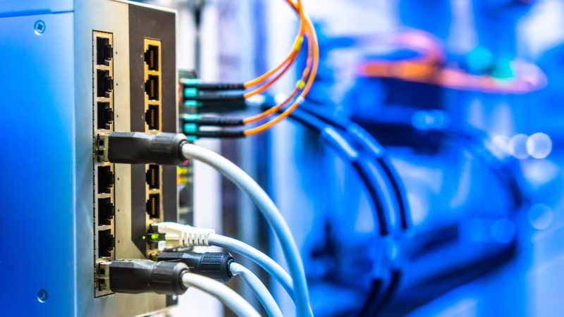 Electrical Circuits.  The electric wire behind the control board with lighting effect,Industrial Electrical Concept. Wiring PLC Control panel with wires industrial factory
