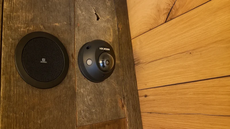 Apart speaker mounted near a Hikvision dome CCTV camera.
